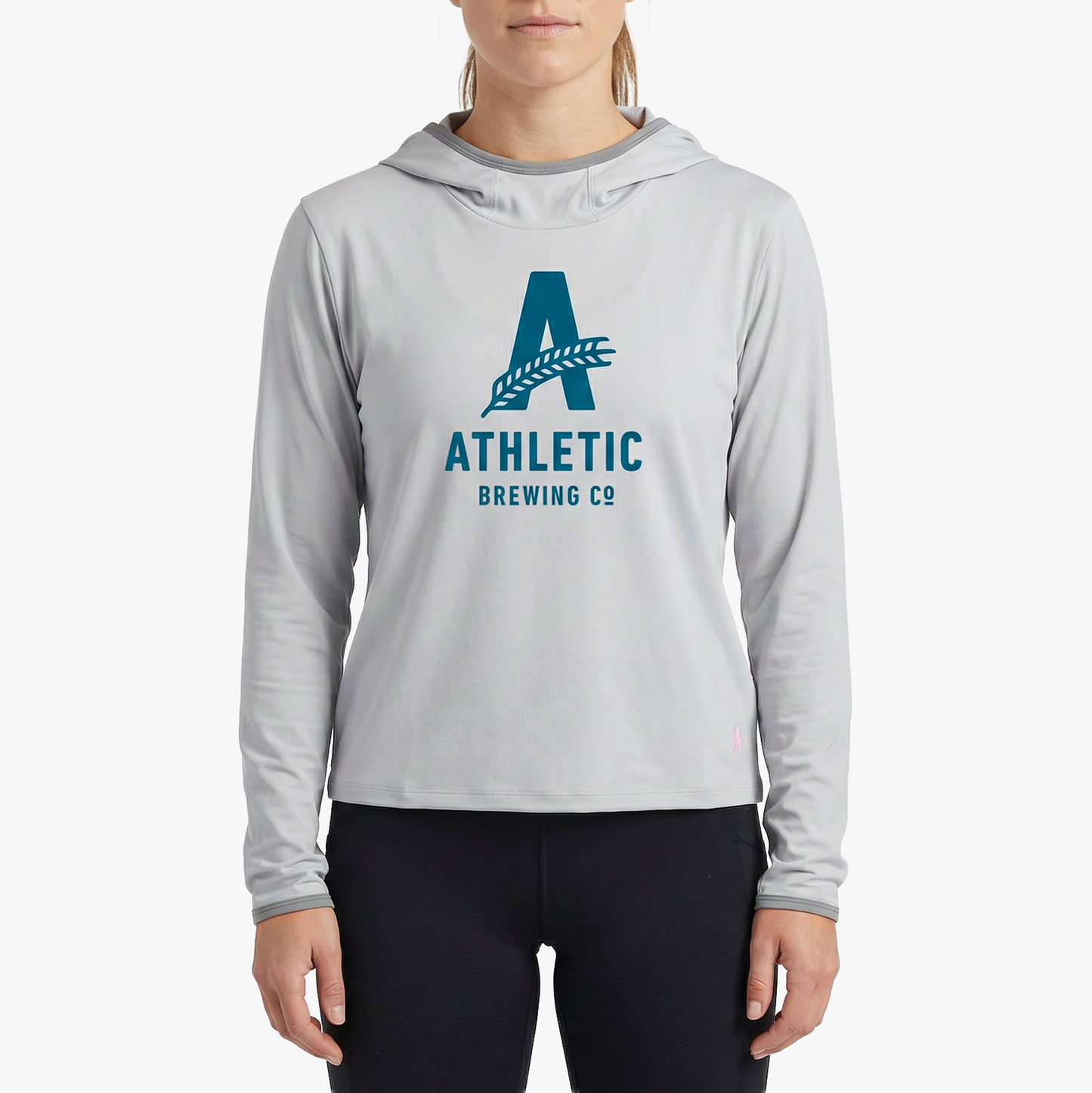 A model wearing the light grey Athletic Brewing Co. x Cotopaxi Sombra sun hoodie.