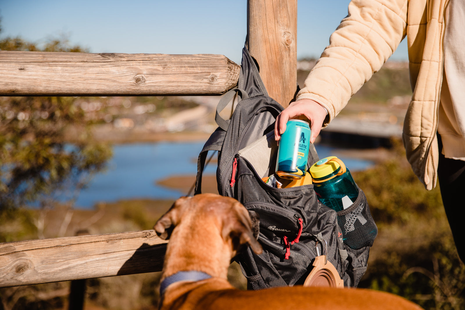 Pulling a can of Run Wild out of a backpack