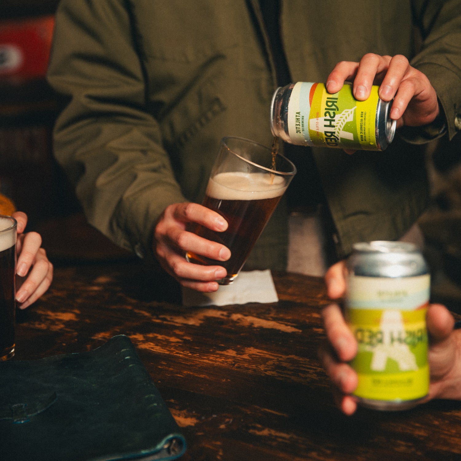 Person pouring Irish Red from a can into a glass.