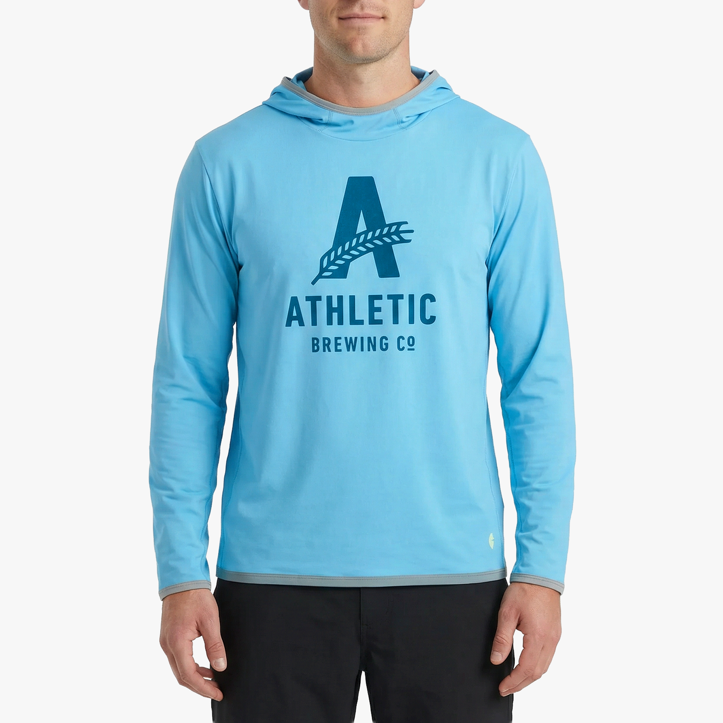 A model wearing the light blue Athletic Brewing Co. x Cotopaxi Sombra sun hoodie.