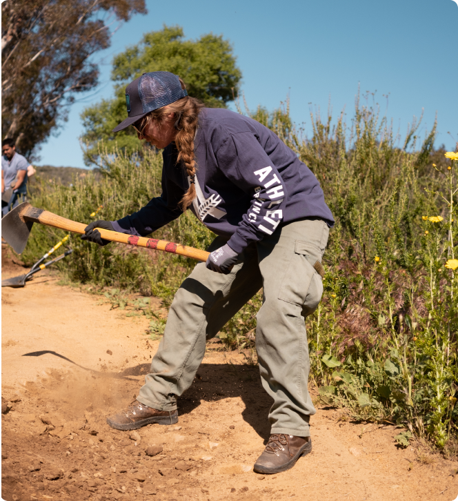 person cleaning trail