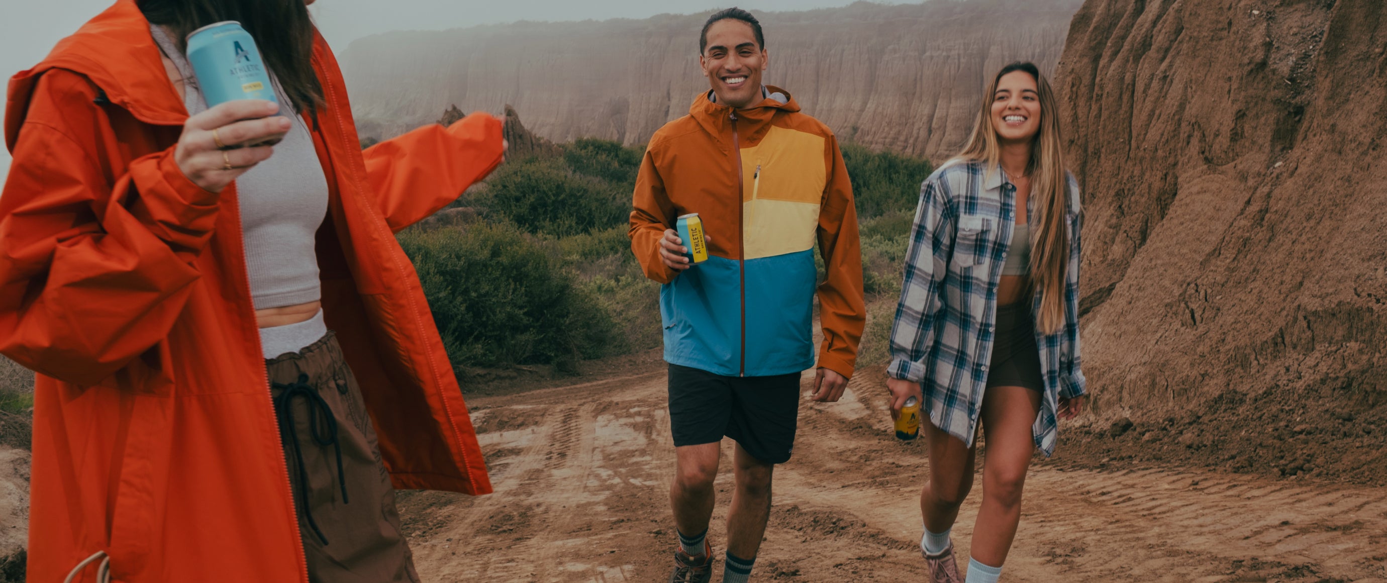 group of people hiking with brews in hand