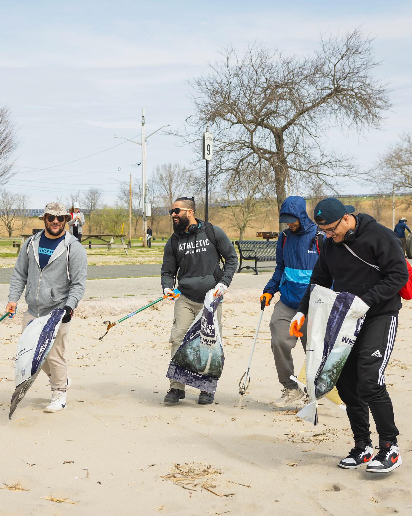 Athletic team members picking up trash