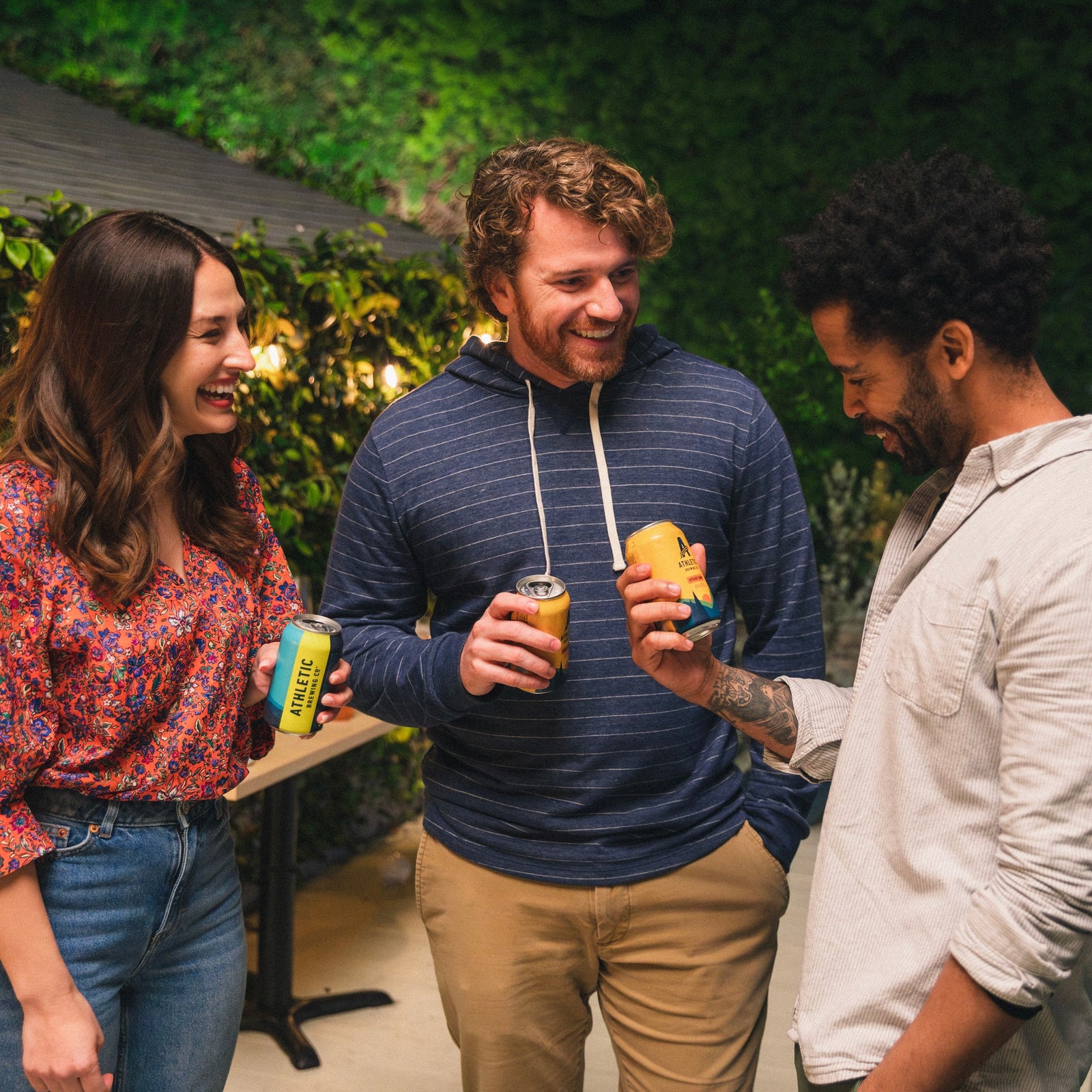 3 people enjoying Athletic NA beer