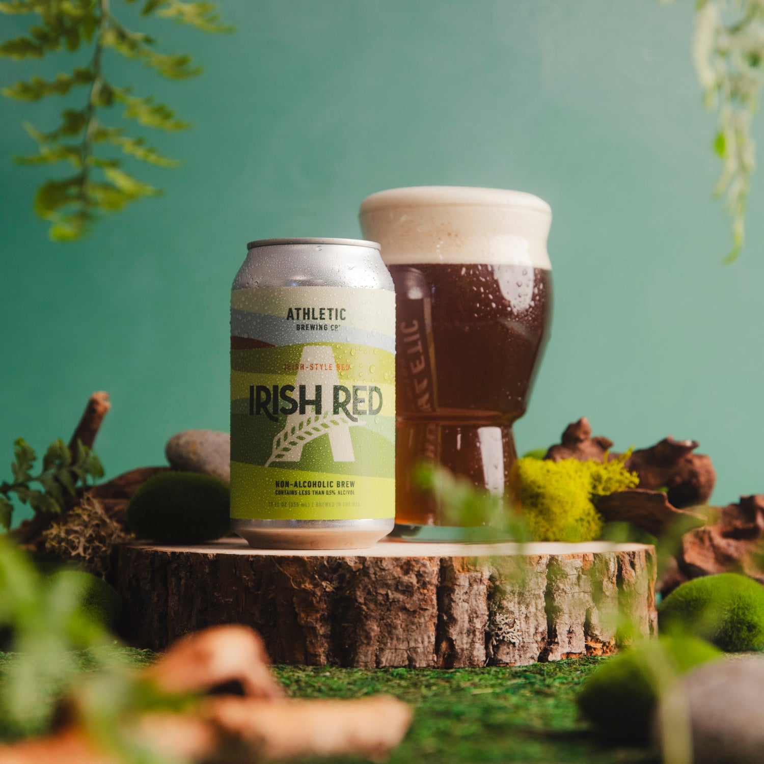 Irish Red can and glass on a wooden stump.