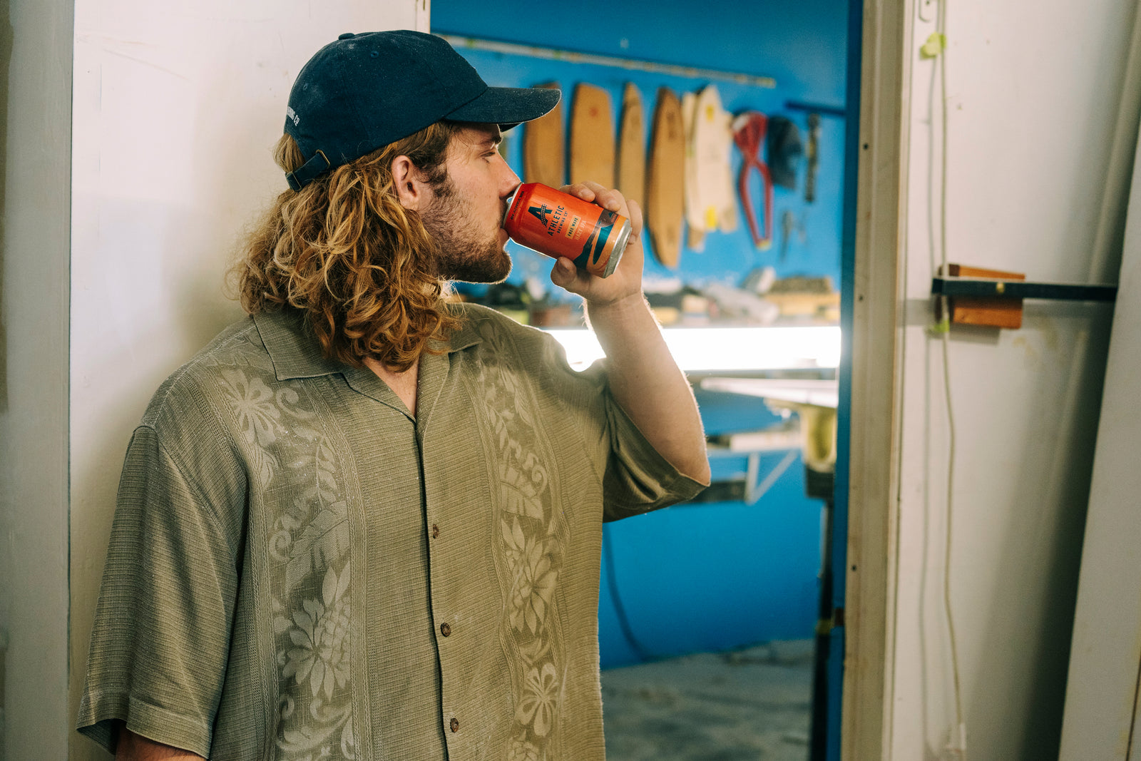 Surfer drinking a can of Free Wave