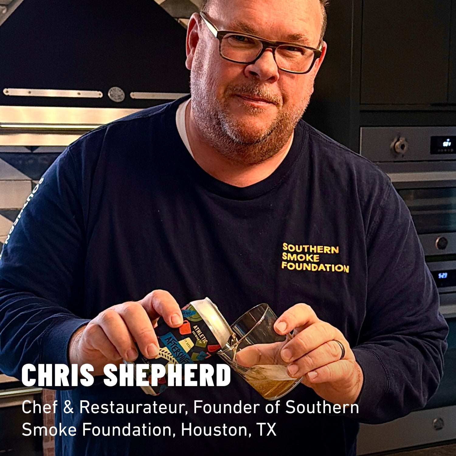 Chris Shepherd in a blue shirt pouring a can of non-alcoholic beer into a glass