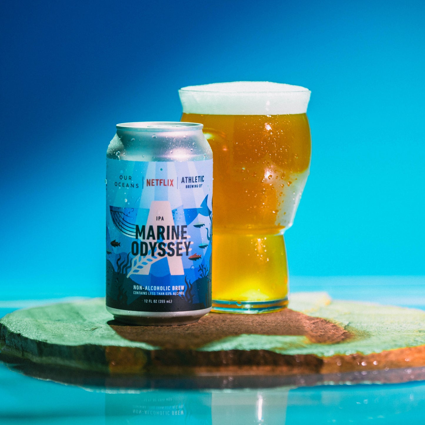 can and package of Marine Odyssey brew on rock on water