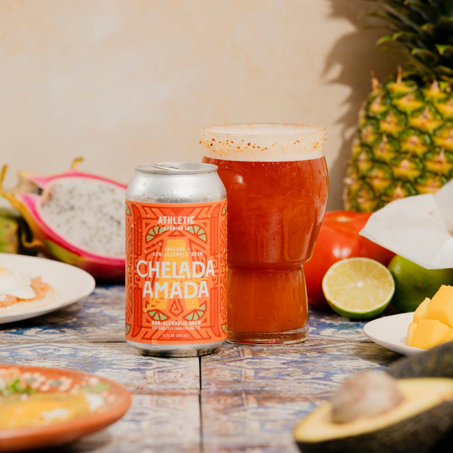 glass with chelada amada on a table with fruits 