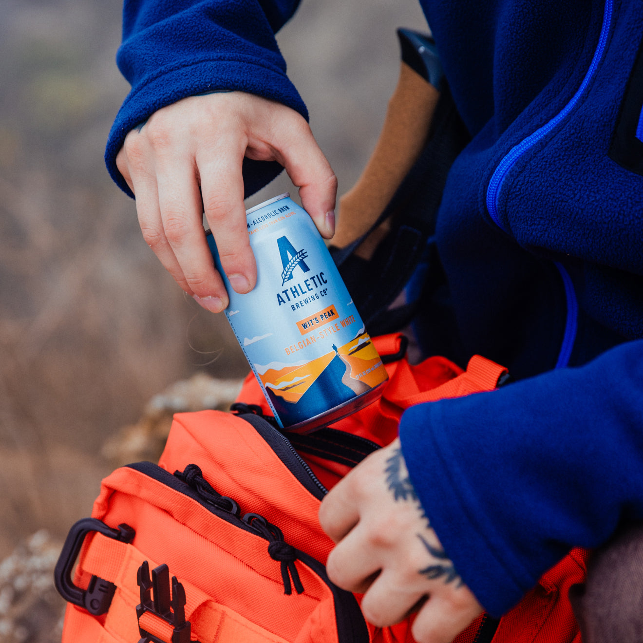 Pulling out a can of Wit's Peak from bag