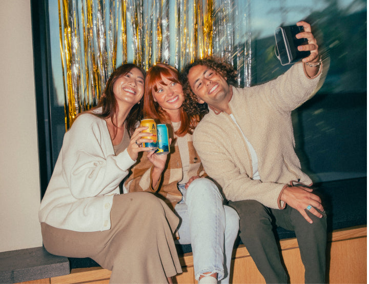 people taking a slefie with brews