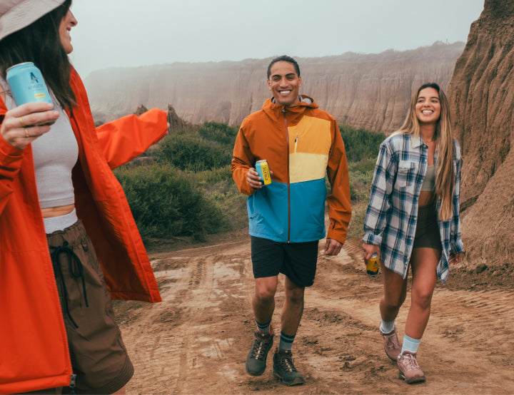 group of friends hiking and drinking brews