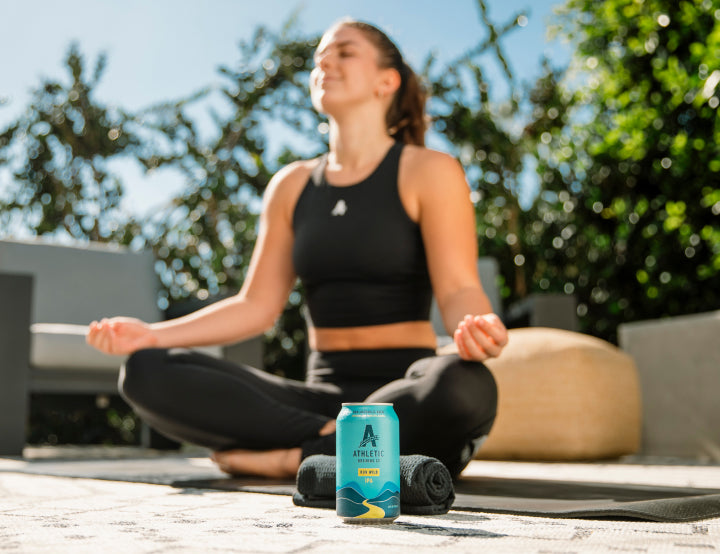 person doing yoga with a brew