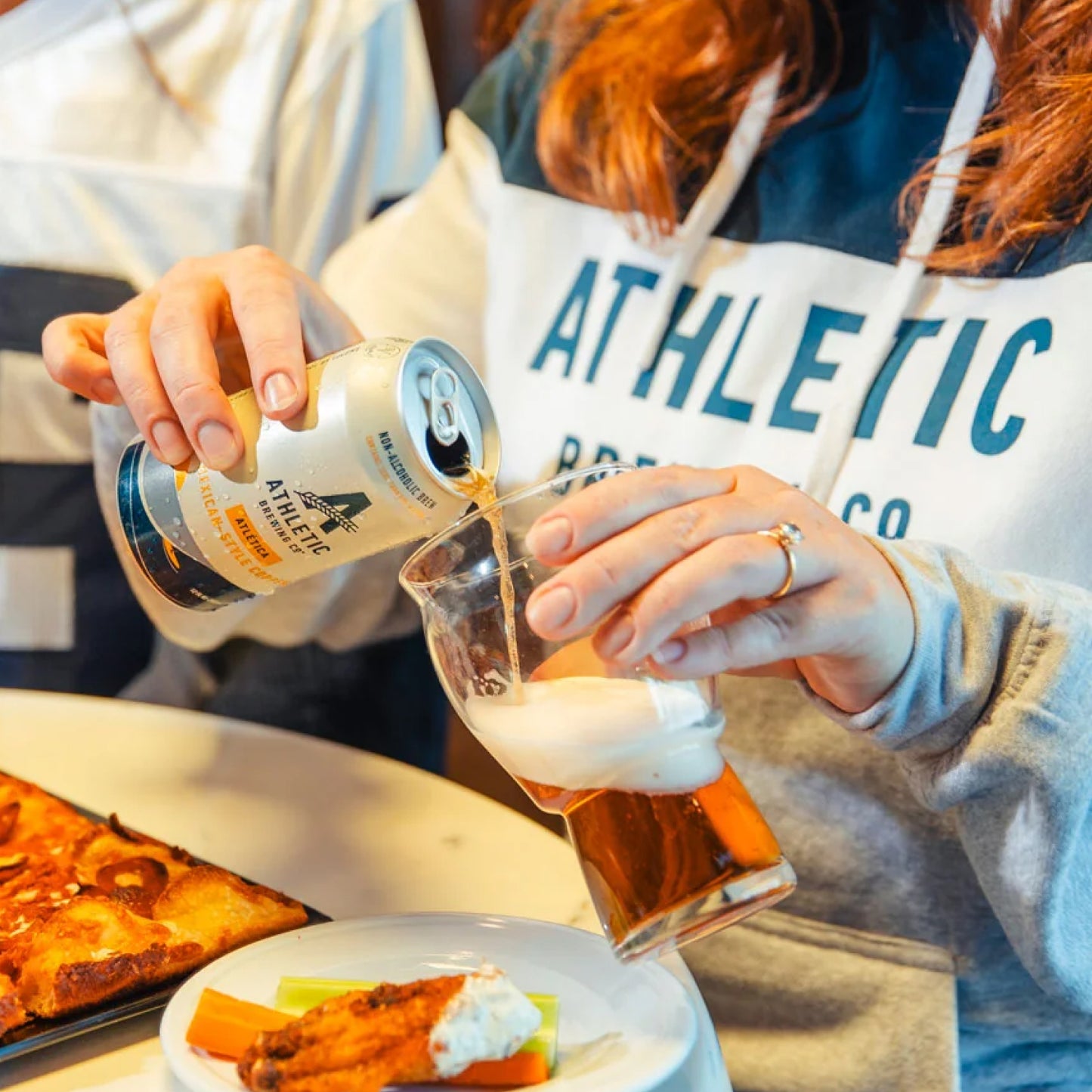 Varsity Hooded Sweatshirt lifestyle with NA beer