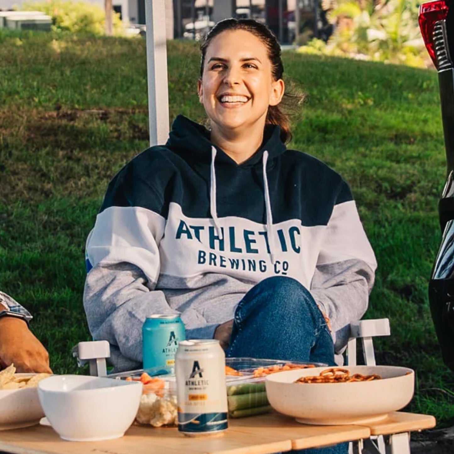 Varsity Hooded Sweatshirt model with NA beer cans