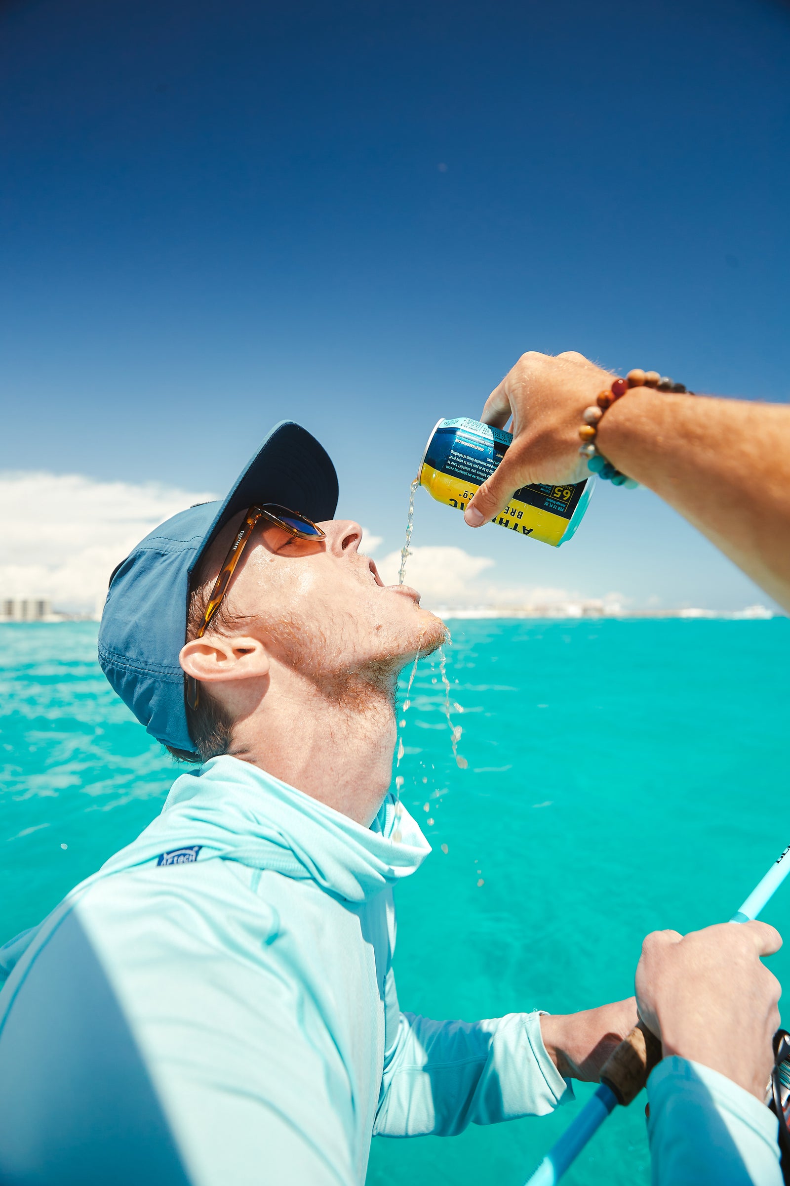 Pouring Run Wild into mouth standing on a boat